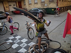 A rider plays "ring around the bike messenger" at a stop on the Babes in Bikeland race in 2011. Photo by Bjorn Christianson via Flickr. Click for original.
